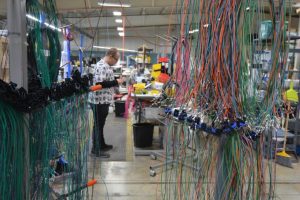 DECA team member working on cable production.